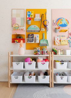 two shelves with bins and baskets on them in a child's playroom