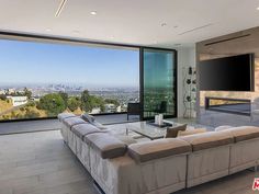 a living room with large windows overlooking the city