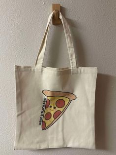 Have A Slice Day Tote Bag | Market Totebag , Food Totebag , Reusable Totebag , Cute Totebag , Shopping Totebags, Canvas Totebag WHAT IS INCLUDED? - Have A Slice Day Tote Bag DETAILS "Have A Slice Day" Tote Bag - your perfect companion for a cheerful and eco-friendly lifestyle! This spacious and durable tote features a fun, pizza-inspired design that brightens up your day. Ideal for shopping, beach trips, or everyday use. Carry your essentials with a slice of joy and spread positivity wherever you go with the "Have A Slice Day" Tote Bag! -Print on One side -100% Polyester  PLEASE NOTE -Dimensions: 15"x16"  -There is no refund on our products. Please message me if you have any concerns with your item.  SHIPPING: Orders will be shipped 1-3 Business Days  FOR MORE LISTINGS, PLEASE CHECK OUT: h Reusable Canvas School Bag, Reusable Tote Bag For Grocery, Reusable Tote Lunch Bag For Daily Use, Reusable Tote Bag For Groceries, Rectangular Reusable Grocery Bags, Rectangular Reusable Canvas Bag For School, Large Eco-friendly School Bag, Casual Reusable Grocery Bags, Large Reusable Bags For Everyday Use