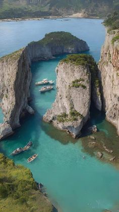 several boats are in the water near some cliffs