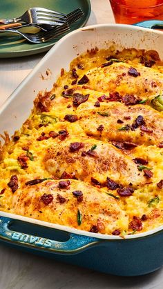 a casserole dish with meat, cheese and vegetables in it on a table