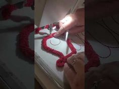 someone is making a heart out of yarn