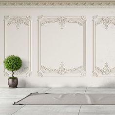 an empty room with two vases and a potted plant on the floor next to it