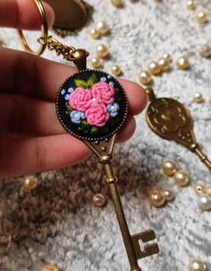 a person holding a key with flowers on it