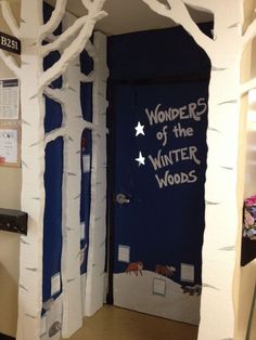 a door decorated with white trees and the words wonder of the winter woods