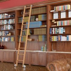 a ladder leaning up against a bookshelf in a room filled with wooden shelves