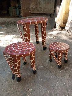 three giraffe print stools sitting on the ground