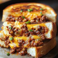 two pieces of bread with cheese and chili on them