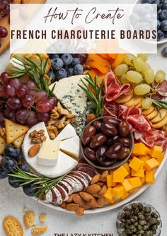 a platter filled with cheese, crackers and grapes