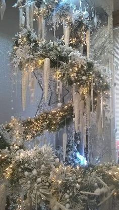 a christmas tree is decorated with snow and icicles