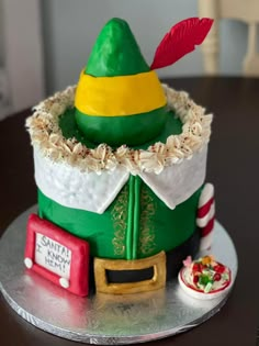 a cake decorated with an elf's hat and candy canes on a table