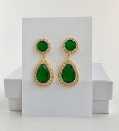 Brilliant & luxurious!! I've created the super sparkly top quality green emerald cubic zirconia teardrop bridal set in gold plated brass setting. The includes : # Earrings featuring a large teardrop with pear cut green emerald cubic zirconia center surrounded by tiny round zirconia crystals. Teardrop dangles from a ear stud with brilliant cut clear cubic zirconia center and surrounded by tiny round zirconia crystals. This entire halo setting gives a brilliantly beautiful effect. Total length Green Drop Jewelry For Wedding, Green Teardrop Bridal Earrings For Wedding, Green Crystal Bridal Earrings For Wedding, Green Cubic Zirconia Bridal Earrings, Green Wedding Jewelry, Green Gold Jewelry, Rhodium Jewelry, Gold Earrings Wedding, Crystal Jewelry Sets