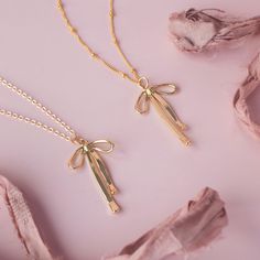 Make a statement with this trendy Bow Necklace. Ribbons have been all the rave this season, and we found the perfect way to get on this trend. …………………………………. Details: Pendant Is Gold Filled or Silver Plated measuring approx. 33.4mm x 19mm x 2.4mm Chain is 14K Gold Filled or Sterling Silver Size Inclusive and can be made in any size needed Average necklace length is 18" About Your Jewelry If you are not wearing your jewelry it is best to store it in a cool, dry place such as your gift box that is Gold Ribbon Necklace, Dainty Metal Necklace For Parties, Trendy Jewelry For Valentine's Day Party, Minimalist Necklaces For Valentine's Day Party, Valentine's Day Party Jewelry With Adjustable Chain, Silver Necklace Party Gift, Party Necklaces As Gifts, Silver Necklace For Party Or Gift, Silver Necklace For Party And Gift