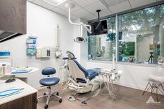 a dental office with blue and white chairs