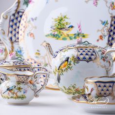 the tea set is decorated with birds and flowers