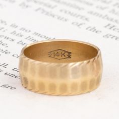 There’s something undoubtedly special about vintage and antique gold bands, especially when they come chock full of intricate details such as this one! With soft but ridged edges, plus ever-so-slightly fluted surfaces, we love the softened texture that wraps all around this baby. A wide, bold fit and a buttery feel on the hands - what more could you ask for? 14kt yellow gold Size 7 but fits more like a 6-6.5 due to the wider band 5.9 grams in total weight The band is 7.6mm wide Heirloom Yellow Gold Thick Band, Heirloom Thick Band In Yellow Gold, Heirloom Gold Thick Band, Heirloom Style Thick Gold Band, Heirloom Thick Gold Band, Heirloom 14k Gold Engraved Bands, 14k Yellow Gold Hammered Band, Classic Yellow Gold Engraved Ring In Brass, Classic Yellow Gold Engraved Brass Ring