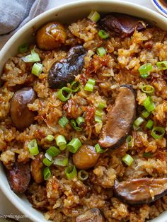 a white bowl filled with rice and sausage