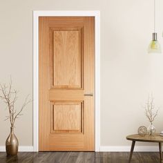 an empty room with a wooden door and vases on the floor next to it