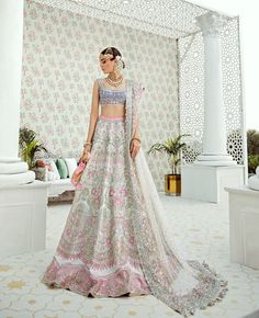 This festive lehenga and choli is the most adored number of our collection, ideal for brides or bridesmaids. The blue tulle choli is hand-worked and lined with Satin. The raw silk Kora and Pink lehenga is hand-worked with pearls, Swarovskis, dabka, nakshi, kora, gold sequins, and crystals. It is matched with a Kora tulle embroidered and embellished dupatta finished with a four-sided accent colored border. Lehenga can be customized in any color of your choice. Reception Lehenga Bridal, Lehenga White, Republic Womenswear, Modelling Career, Nida Azwer, Raw Silk Lehenga, Indian Lehenga Choli, Sana Safinaz, Lehenga Skirt