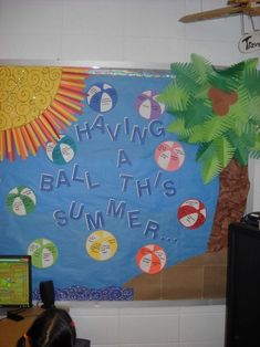 a bulletin board that says having a ball this summer with palm trees and beach balls