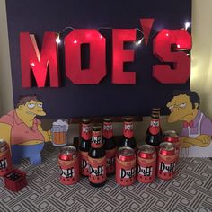 the simpsons characters are standing in front of beer cans and lighted letters that spell out moe's