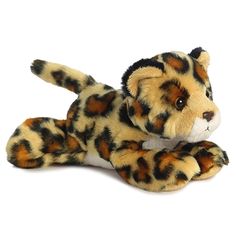 a stuffed animal is laying down on the ground with it's paw up and eyes wide open