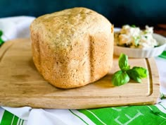 a loaf of bread sitting on top of a wooden cutting board