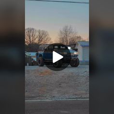 a blue jeep parked in front of a building