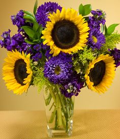 a vase filled with purple and yellow flowers