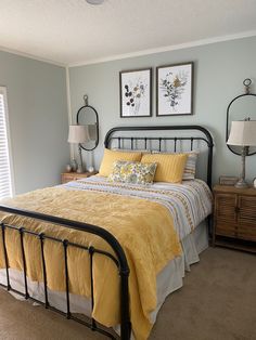 a bed room with a neatly made bed and two pictures on the wall above it