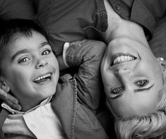 two children laying on the floor with their mouths open and one child looking at the camera