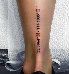 a woman's foot with the word love written in red ink on her lower leg