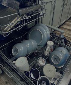 an open dishwasher with dishes in it