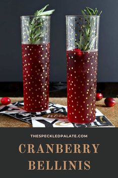 two glasses filled with cranberry bellini and rosemary sprigs