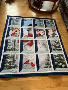 a quilted table runner with red cardinals and pine trees in the snow on it