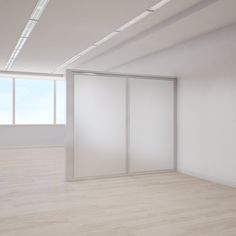 an empty room with white walls and wooden flooring is shown in this image, there are two sliding glass doors on the wall