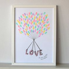 an art print with the word love written on it in front of a white shelf