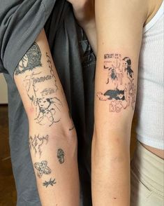 two people with tattoos on their arms and one is holding the other's arm