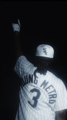 a baseball player with his hand up in the air