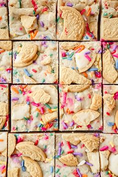 cookies and sprinkles are arranged in squares on a table top with white frosting