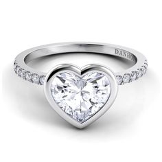 a heart shaped diamond ring with diamonds on the band