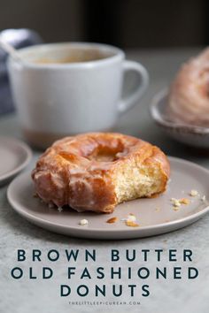 a donut sitting on top of a plate next to a cup of coffee