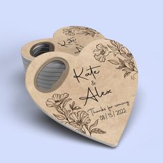 a wooden heart shaped box with a couple's names on it