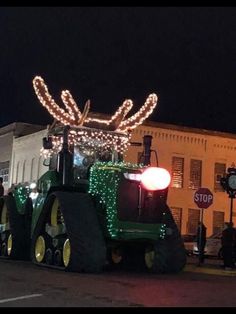 a tractor decorated with christmas lights on the street