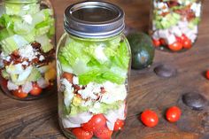 two mason jars filled with different types of vegetables