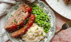 meatloaf, mashed potatoes and green peas on a plate with a fork