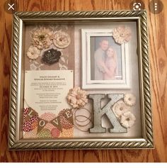 a wooden table topped with a framed photo and letters that spell out the word love