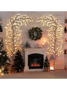 a fireplace with christmas lights and wreaths on the mantle