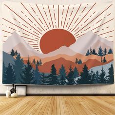 a tapestry hanging on the side of a wall with mountains and trees in front of it