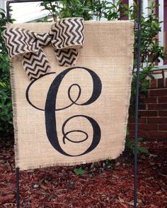 a burlocked sign with a bow on it in front of a house